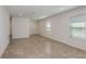 Spacious living room with tile flooring, recessed lighting, and neutral walls, offering a versatile space for relaxation at 9080 Wildlight Trl, Wildwood, FL 34785