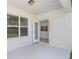 Patio featuring a view of the outdoor landscape and an open doorway leading into the kitchen at 9080 Wildlight Trl, Wildwood, FL 34785