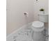 Simple, clean bathroom with marble floor and white toilet at 1716 Palmer Ave, Winter Park, FL 32789