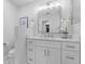 Bright bathroom with white cabinets and marble-look tile at 1716 Palmer Ave, Winter Park, FL 32789