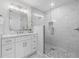 Bathroom with white vanity, walk-in shower, and marble tile at 1716 Palmer Ave, Winter Park, FL 32789