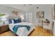 Bright bedroom with a queen bed and wood floors at 1716 Palmer Ave, Winter Park, FL 32789