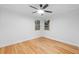 Spacious bedroom featuring hardwood floors and a ceiling fan at 1716 Palmer Ave, Winter Park, FL 32789