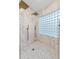 Large walk-in shower with marble tile and glass block window at 1716 Palmer Ave, Winter Park, FL 32789