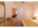 Comfortable bedroom with a dresser, mirror, closet and a glimpse into the dining room at 308 New Providence # 308, Davenport, FL 33897