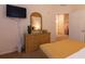 Comfortable bedroom with a dresser, mirror, TV, closet and a glimpse into the bathroom at 308 New Providence # 308, Davenport, FL 33897