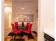 Bright dining area with red chairs, round table, and stylish world map artwork, leading to other rooms at 308 New Providence # 308, Davenport, FL 33897