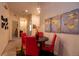 Inviting dining area with a round table, four red chairs, and attractive wall art, set in a cozy space at 308 New Providence # 308, Davenport, FL 33897