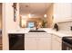 Well-lit kitchen with white countertops, a black sink, and a view into the open concept living space at 308 New Providence # 308, Davenport, FL 33897