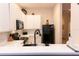 Well-lit kitchen features white cabinetry, subway tile backsplash, modern appliances, and a breakfast bar at 308 New Providence # 308, Davenport, FL 33897