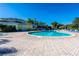 Large outdoor swimming pool surrounded by lounge chairs and palm trees on a sunny day at 308 New Providence # 308, Davenport, FL 33897