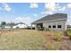 Spacious backyard with new landscaping and a covered patio at 6086 Sacred Oak Ave, Mount Dora, FL 32757