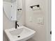 Elegant bathroom with white sink, oval mirror, matte black hardware, and modern fixtures at 6086 Sacred Oak Ave, Mount Dora, FL 32757