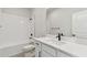 Modern bathroom with white vanity, shower, and black accents at 6086 Sacred Oak Ave, Mount Dora, FL 32757