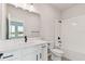 Bathroom features a white vanity, shower and bathtub with all white tile at 6086 Sacred Oak Ave, Mount Dora, FL 32757