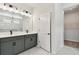 Modern bathroom with double vanity, gray cabinets, white countertops, and tile flooring at 6086 Sacred Oak Ave, Mount Dora, FL 32757