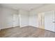 Bright bedroom featuring wood-look floors and access to a full bath at 6086 Sacred Oak Ave, Mount Dora, FL 32757