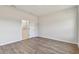 Empty bedroom features wood-look floors, bright walls, and an en-suite bathroom at 6086 Sacred Oak Ave, Mount Dora, FL 32757