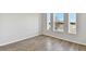 Well-lit bedroom features wood-look floors and multiple windows offering great natural light at 6086 Sacred Oak Ave, Mount Dora, FL 32757