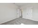 Spacious bedroom with grey carpet and access to hallway at 6086 Sacred Oak Ave, Mount Dora, FL 32757