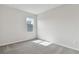 Bright bedroom featuring neutral carpet and a window at 6086 Sacred Oak Ave, Mount Dora, FL 32757