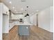 Modern kitchen with white cabinets, a large island, and stainless steel appliances at 6086 Sacred Oak Ave, Mount Dora, FL 32757