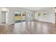 Expansive living room features wood-look floors and sliding glass doors to the backyard at 6086 Sacred Oak Ave, Mount Dora, FL 32757