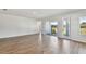 Spacious living area with hardwood floors and sliding glass doors at 6086 Sacred Oak Ave, Mount Dora, FL 32757