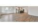 Open floor plan boasting wood-look floors connecting the kitchen and living area at 6086 Sacred Oak Ave, Mount Dora, FL 32757