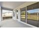 Covered patio with sliding glass doors and view of backyard at 6086 Sacred Oak Ave, Mount Dora, FL 32757