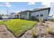 Newly constructed home with a spacious backyard and lush green grass at 6075 Sacred Oak Ave, Mount Dora, FL 32757