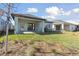 House with covered patio and grassy backyard at 6075 Sacred Oak Ave, Mount Dora, FL 32757