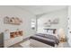 Cozy bedroom with playful shelving, a comfortable bed, and neutral decor at 6075 Sacred Oak Ave, Mount Dora, FL 32757