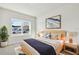Bright bedroom with a comfortable bed, natural light, and a view of the neighborhood at 6075 Sacred Oak Ave, Mount Dora, FL 32757