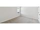 Simple bedroom with carpet and window at 6075 Sacred Oak Ave, Mount Dora, FL 32757