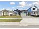 New house with gray and green exterior, stone accents, and a paved driveway at 6075 Sacred Oak Ave, Mount Dora, FL 32757