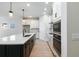 Bright kitchen featuring an island with a sink, stainless steel appliances, and white cabinets at 6075 Sacred Oak Ave, Mount Dora, FL 32757