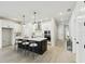 Bright kitchen featuring an island with a sink, pendant lighting, stainless steel appliances, and white cabinets at 6075 Sacred Oak Ave, Mount Dora, FL 32757
