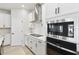 Modern kitchen with white cabinets and stainless steel appliances at 6075 Sacred Oak Ave, Mount Dora, FL 32757