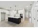 Modern kitchen with island, stainless steel appliances, and white cabinetry at 6075 Sacred Oak Ave, Mount Dora, FL 32757