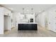 Bright kitchen featuring an island with a sink, stainless steel appliances, white cabinets, and recessed lighting at 6075 Sacred Oak Ave, Mount Dora, FL 32757