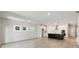 Spacious living room with hardwood floors, natural light, and a view of the kitchen at 6075 Sacred Oak Ave, Mount Dora, FL 32757