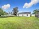 Sprawling backyard with a lush green lawn and a privacy fence at 7713 Manor Dr, Lakeland, FL 33810