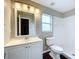 Bright bathroom featuring a white vanity, modern fixtures, and a walk-in shower at 7713 Manor Dr, Lakeland, FL 33810