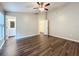 Bedroom features ceiling fan, dark floors, and ensuite bathroom at 7713 Manor Dr, Lakeland, FL 33810