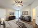 Large bedroom featuring hardwood floors, vaulted ceilings, and two comfy chairs at 7713 Manor Dr, Lakeland, FL 33810
