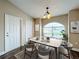Bright dining room features neutral decor and a large window for natural light at 7713 Manor Dr, Lakeland, FL 33810