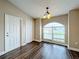 Light and airy entry way has wood floors, large window and access to closet and front door at 7713 Manor Dr, Lakeland, FL 33810