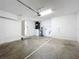 Spacious garage with white walls, a utility closet, and concrete floor at 7713 Manor Dr, Lakeland, FL 33810