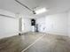 Spacious garage with white walls, a utility closet, and concrete floor at 7713 Manor Dr, Lakeland, FL 33810
